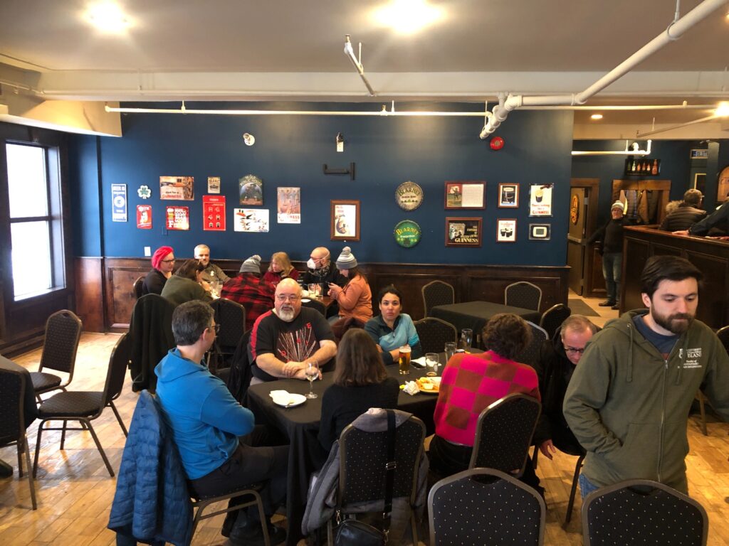 A group of faculty association members around a table at a pub (The Pourhouse). 